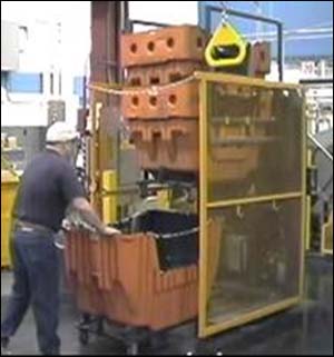 After - One person rolling a hamper into the stacker with two hampers already stacked.