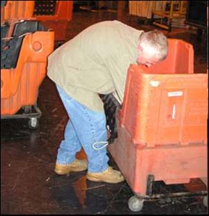 Before  Bending and reaching into a hamper to retrieve a bundle of mail